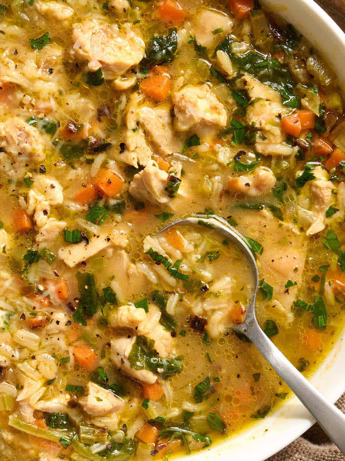 Overhead close up view of a chicken broth bowl.