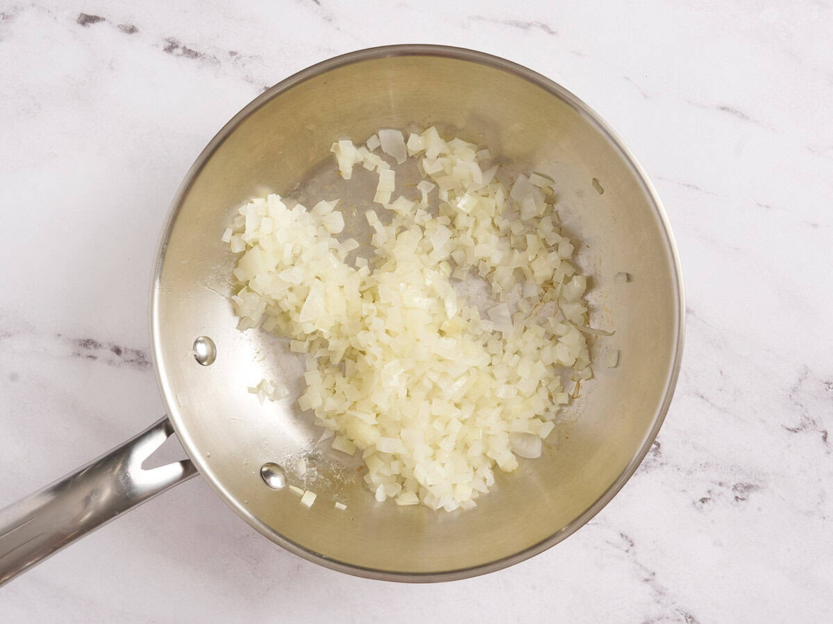 Sauteeing onions in a skillet.