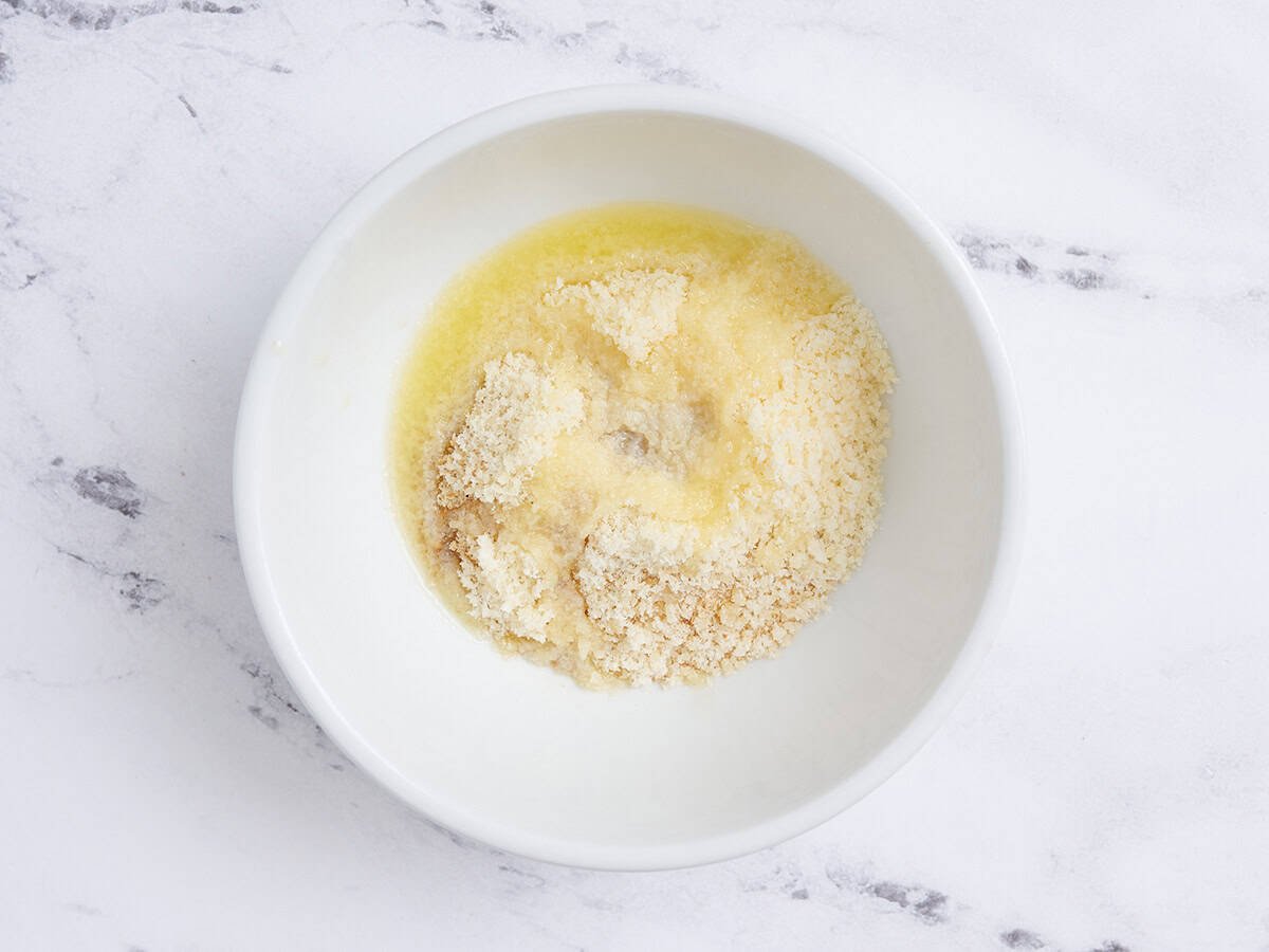 Breadcrumbs, seasonings, and melted butter in a bowl.