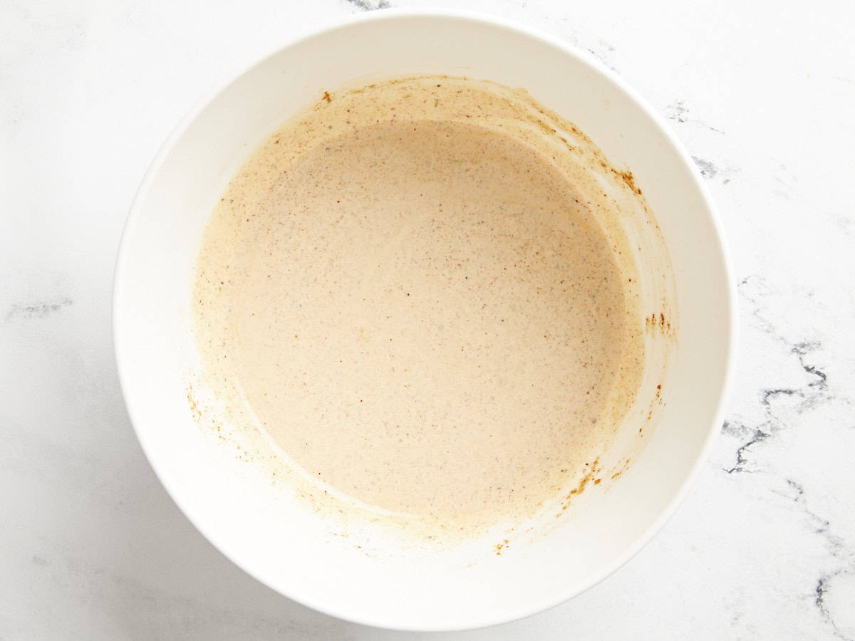 The dressing for Mexican corn salad in a bowl.