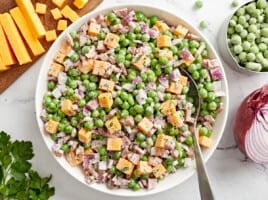 overhead view of pea salad with a spoon.