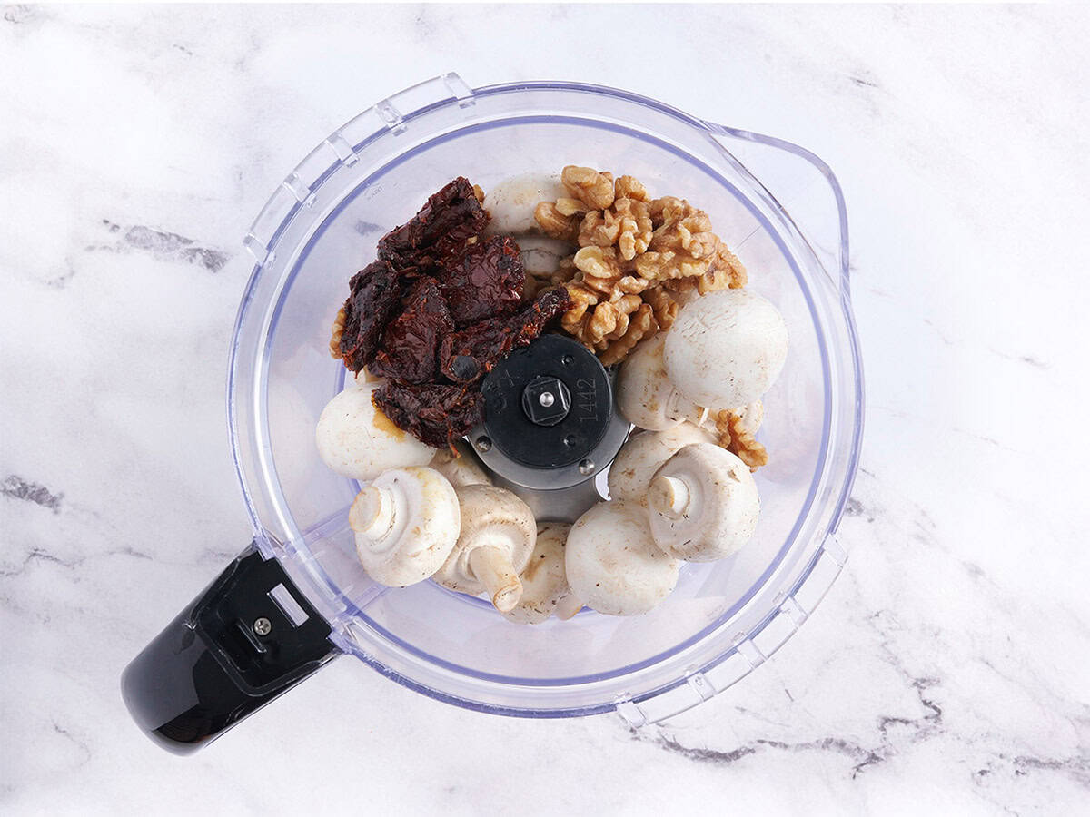 Sundried tomatoes, mushrooms, and walnuts in a food processor.