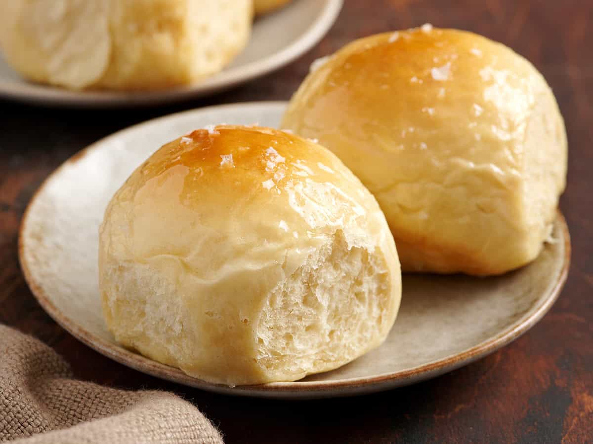 Two Hawaiian rolls on a plate.