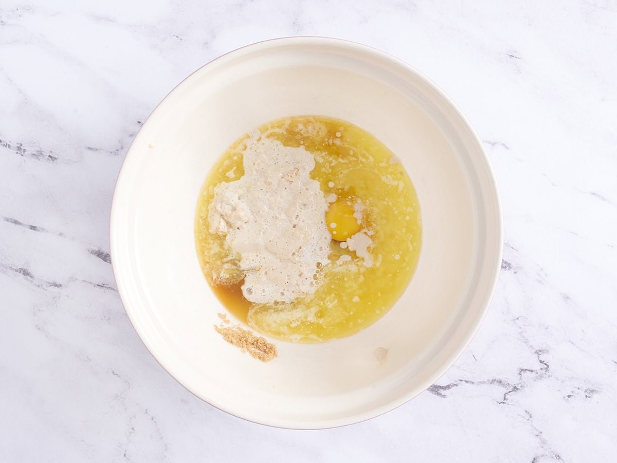Combining wet ingredients with the bloomed yeast.