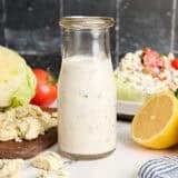 Side view of a bottle of homemade blue cheese dressing.