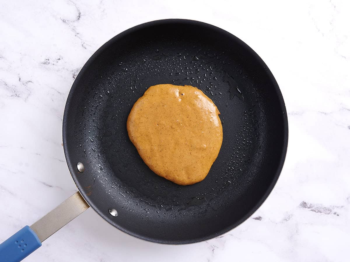 Spiced pancake batter in a skillet.