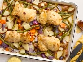 Overhead view of sheet pan honey mustard chicken with veggies.