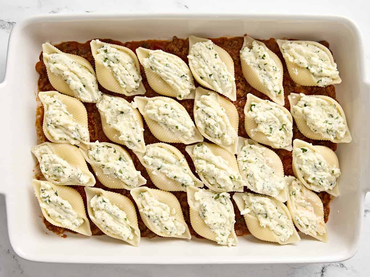 24 stuffed shells in a casserole dish.