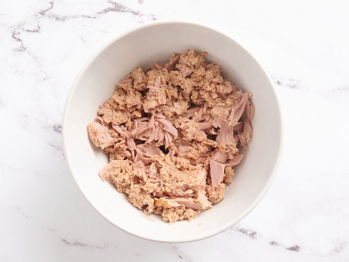 Drained canned tuna in a bowl.