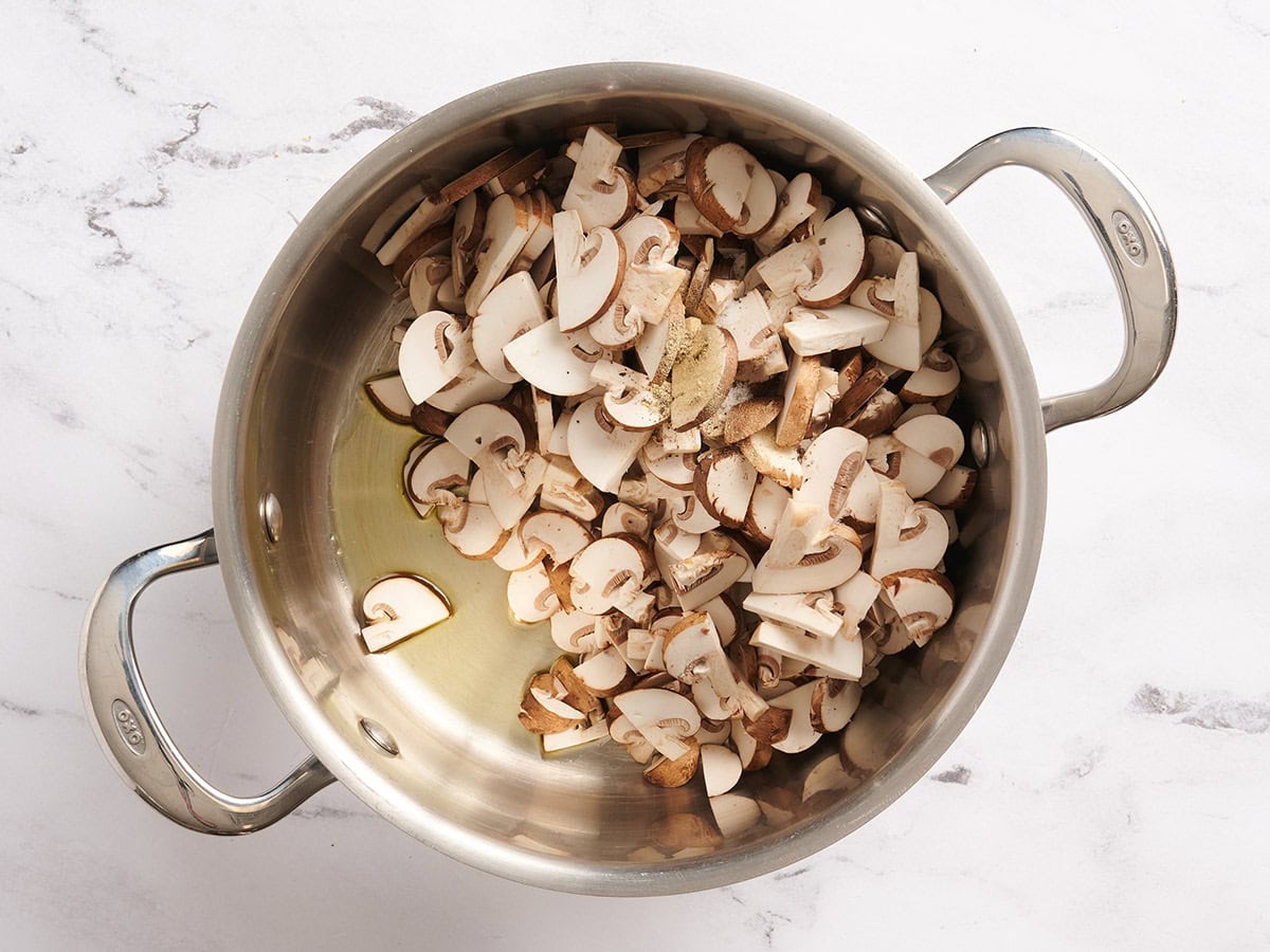 Mushrooms in a pan with oil and seasonings