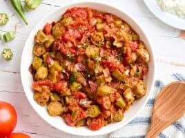 Overhead view of a bowl of stewed tomatoes and okra.