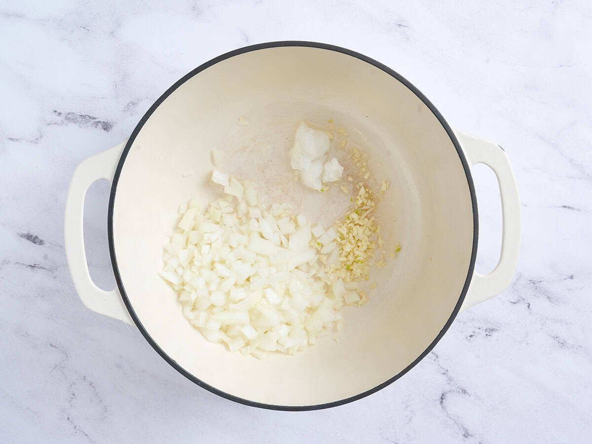 Onion and garlic saut&eacute;ing in a pan.