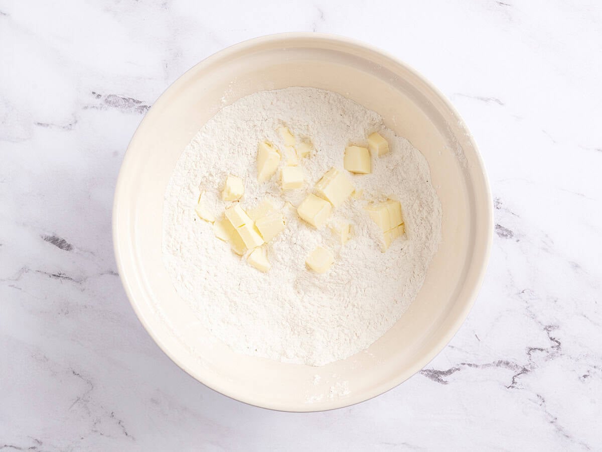 Cubed butter and milk in a bowl.