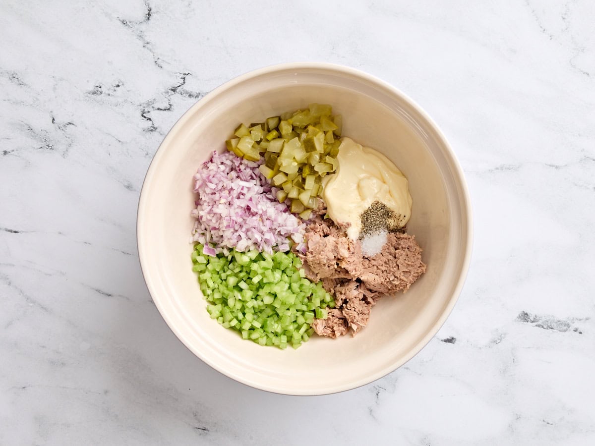 Tuna melt ingredients in a white bowl. 
