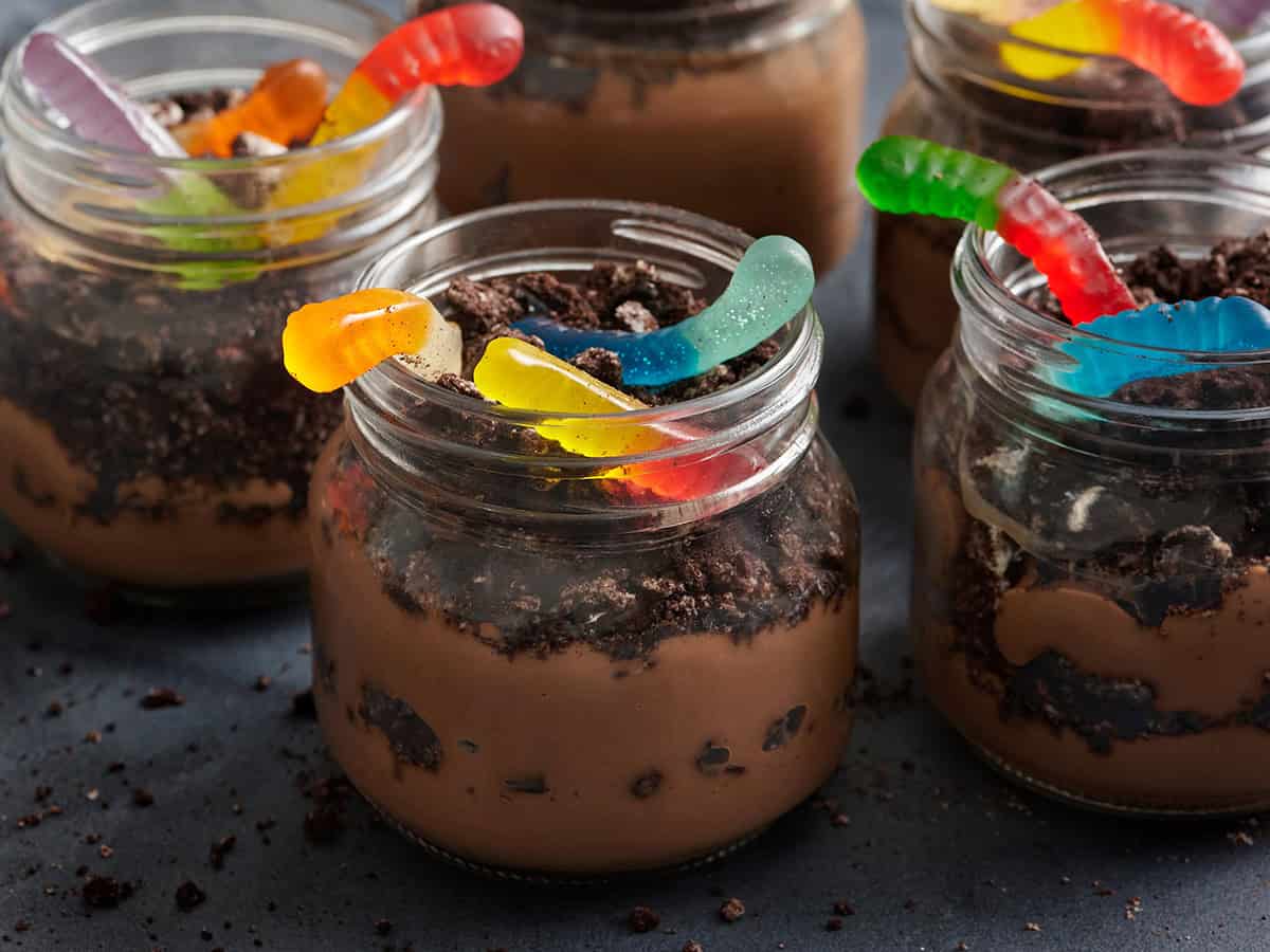 Side view of a worms in dirt dessert pudding cup.
