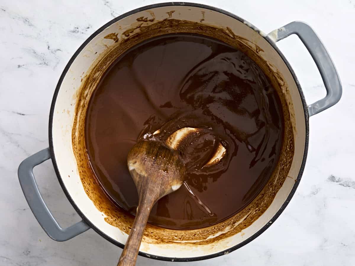 A very dark brown roux in a pot for gumbo.