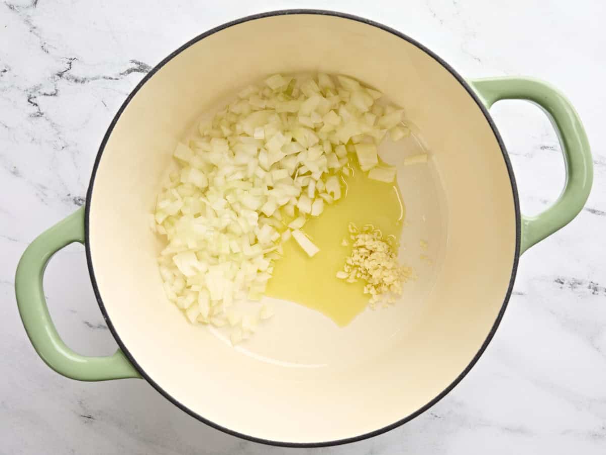 Diced onion and garlic in a pot with oil.