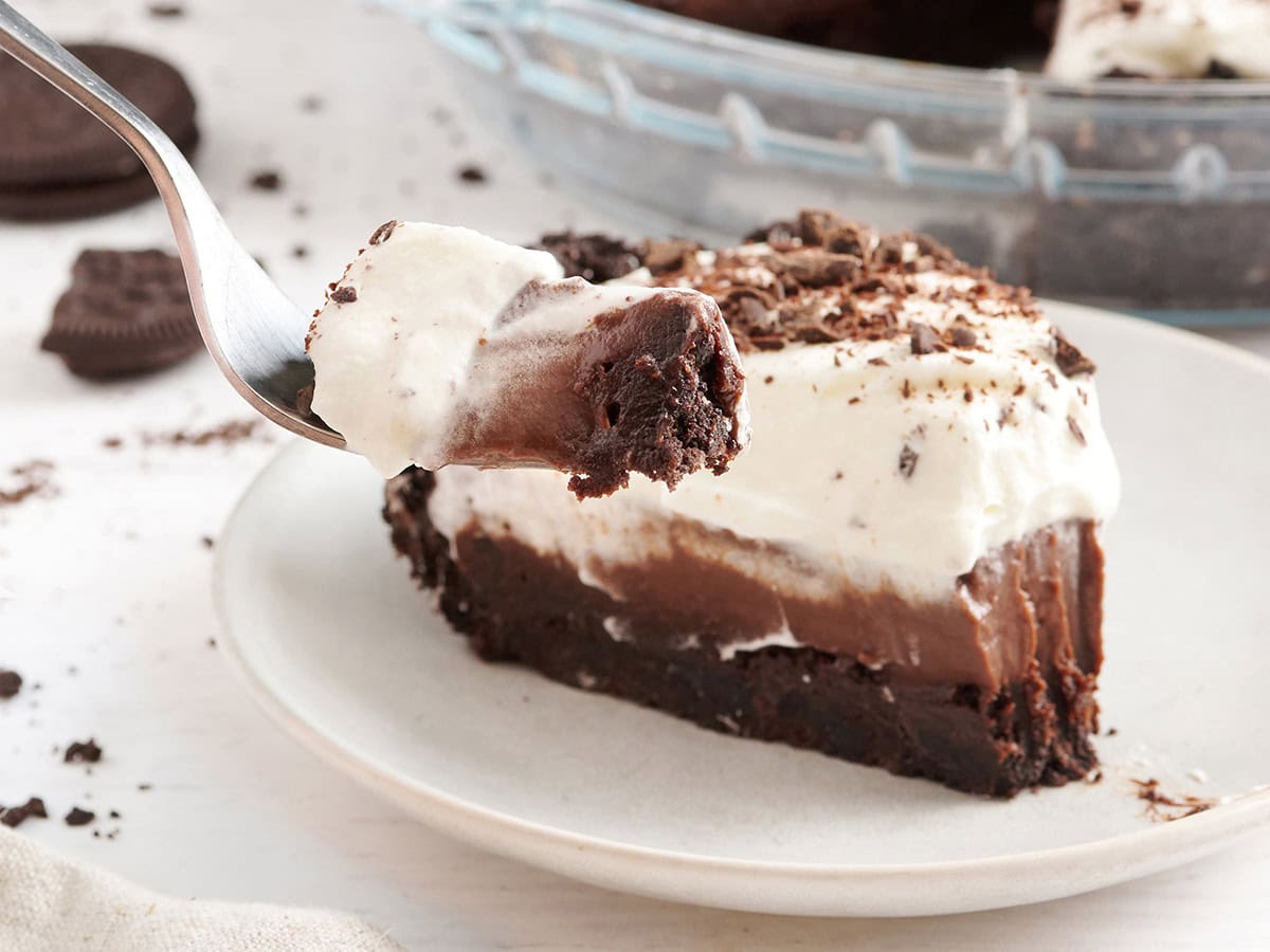 Side view of a slice of Mississippi Mud Pie with a fork taking some.