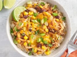 Overhead view of chicken bowls with tacos in a white bowl.
