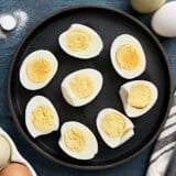 Overhead view of air fryer hard boiled eggs on a plate.