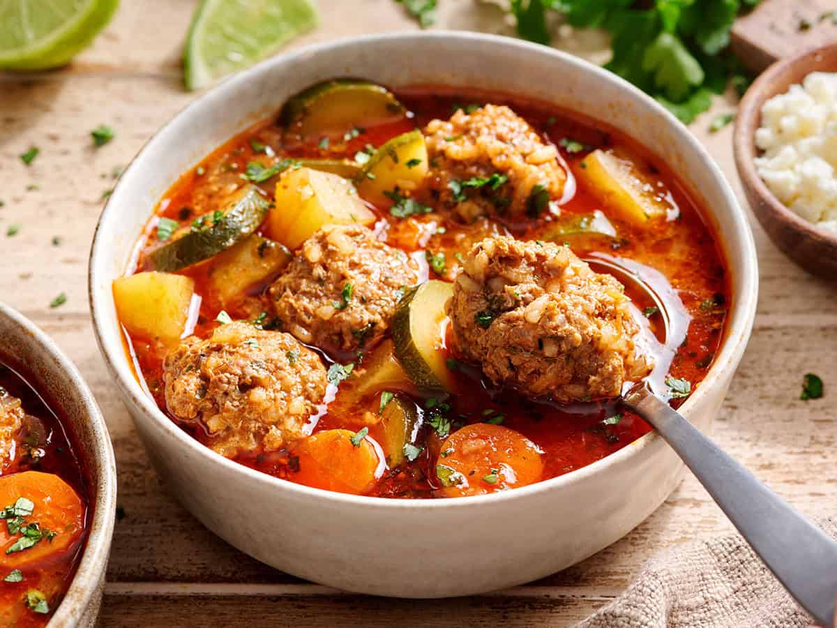 Side view of a bowl of Mexican meatball soup (Albondigas)