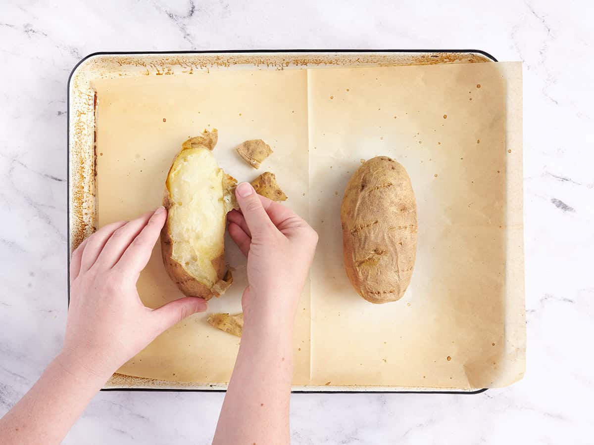 Removing the skin from the potatoes. 