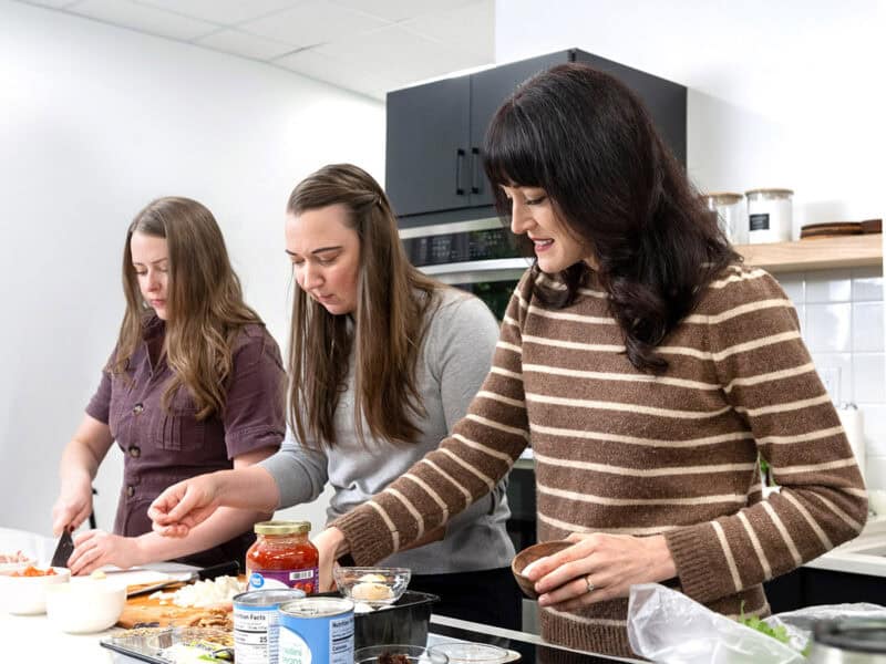three woman developing a budget friendly recipe