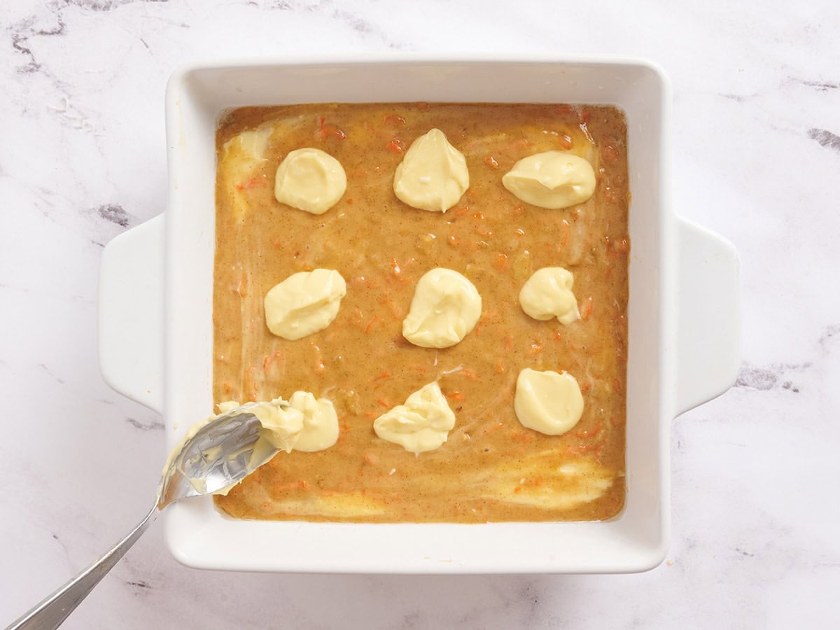 Cheesecake dollops added to the batter for carrot cake bars.