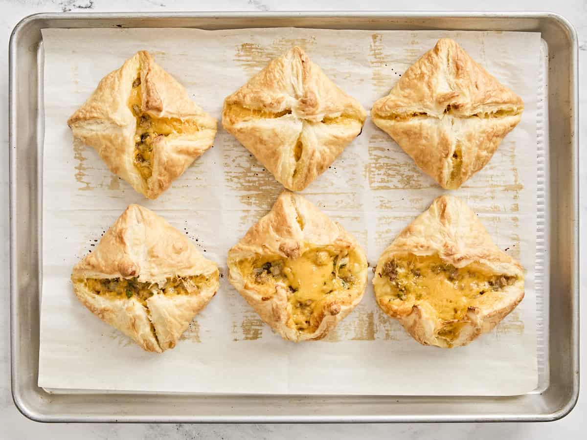 Overhead view of baked sausage and cheese hand pies.