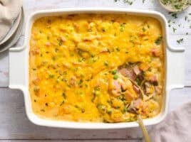 Overhead view of ham tetrazzini in a casserole dish with a spoon.