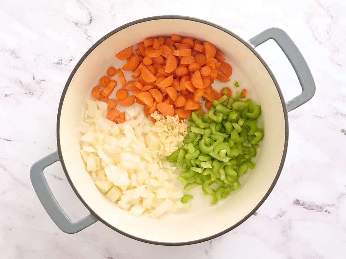 Diced carrots, celery, and onion in a pot.