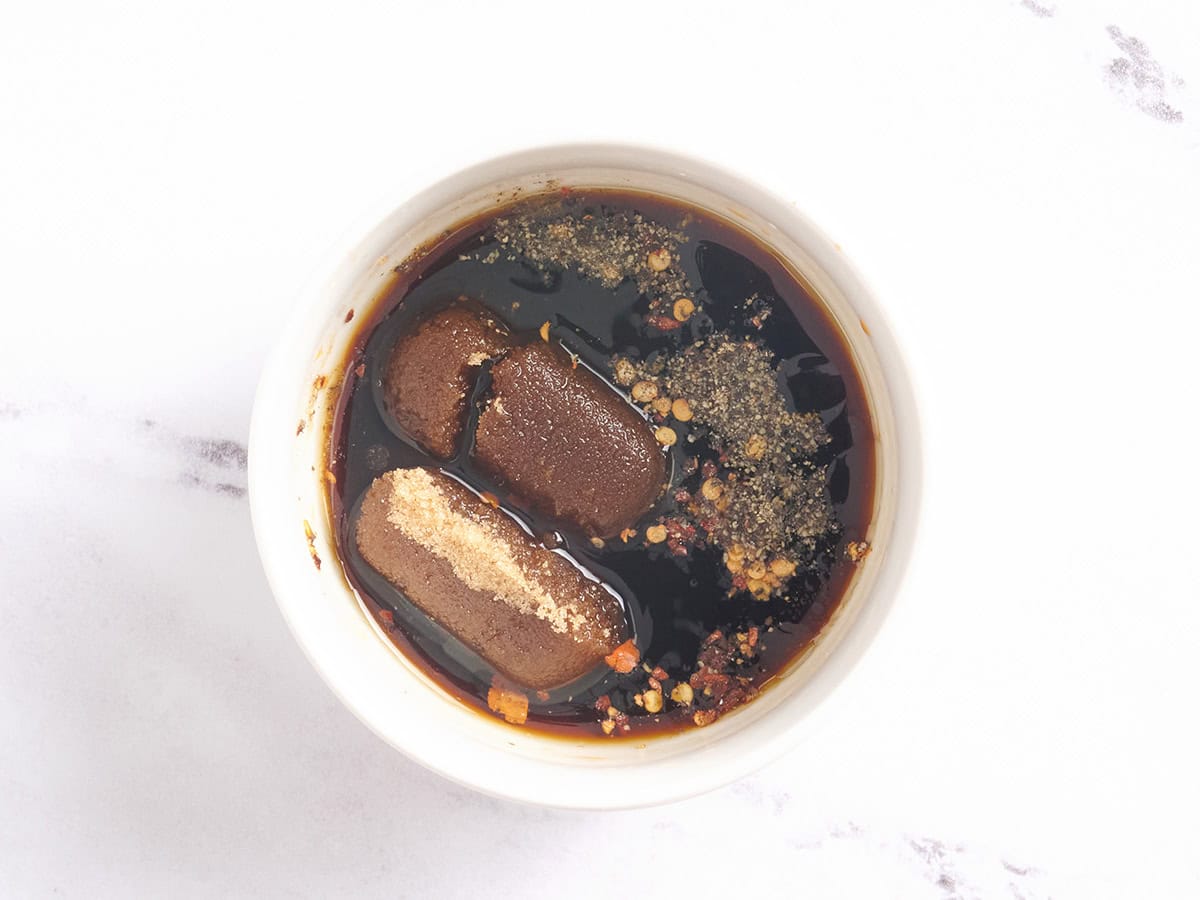 Ingredients for the sauce in a white bowl.