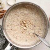 finished rice pudding in the pot topped with sliced almonds.