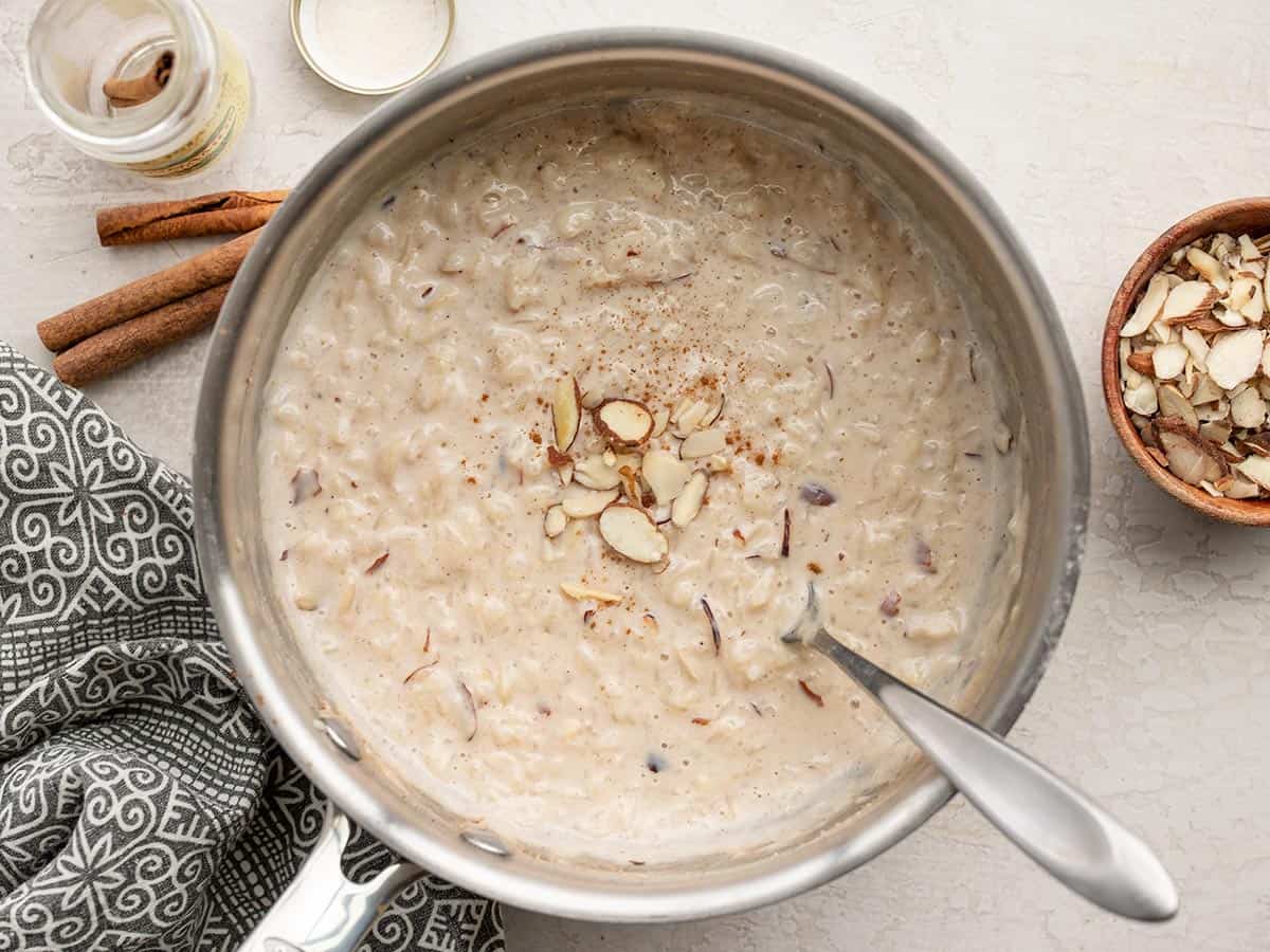 finished rice pudding in the pot topped with sliced almonds.