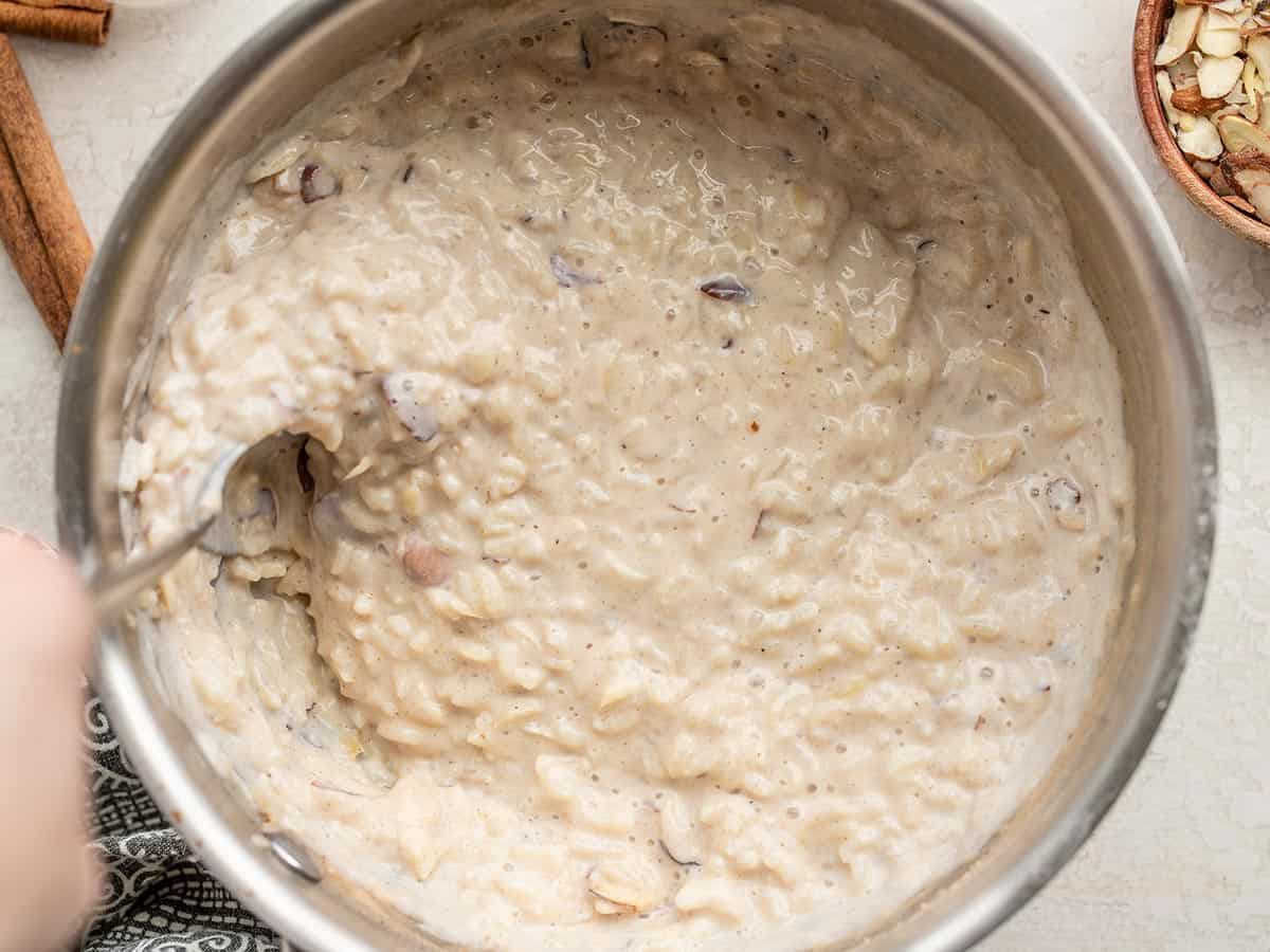 close up of rice pudding being stirred in the pot