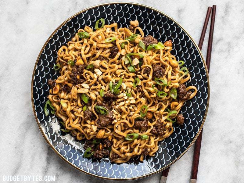 Sweet, salty, rich, and crunchy, these Pork and Peanut Dragon Noodles hit all the bases. It&rsquo;s fast, easy comfort food for busy nights! BudgetBytes.com