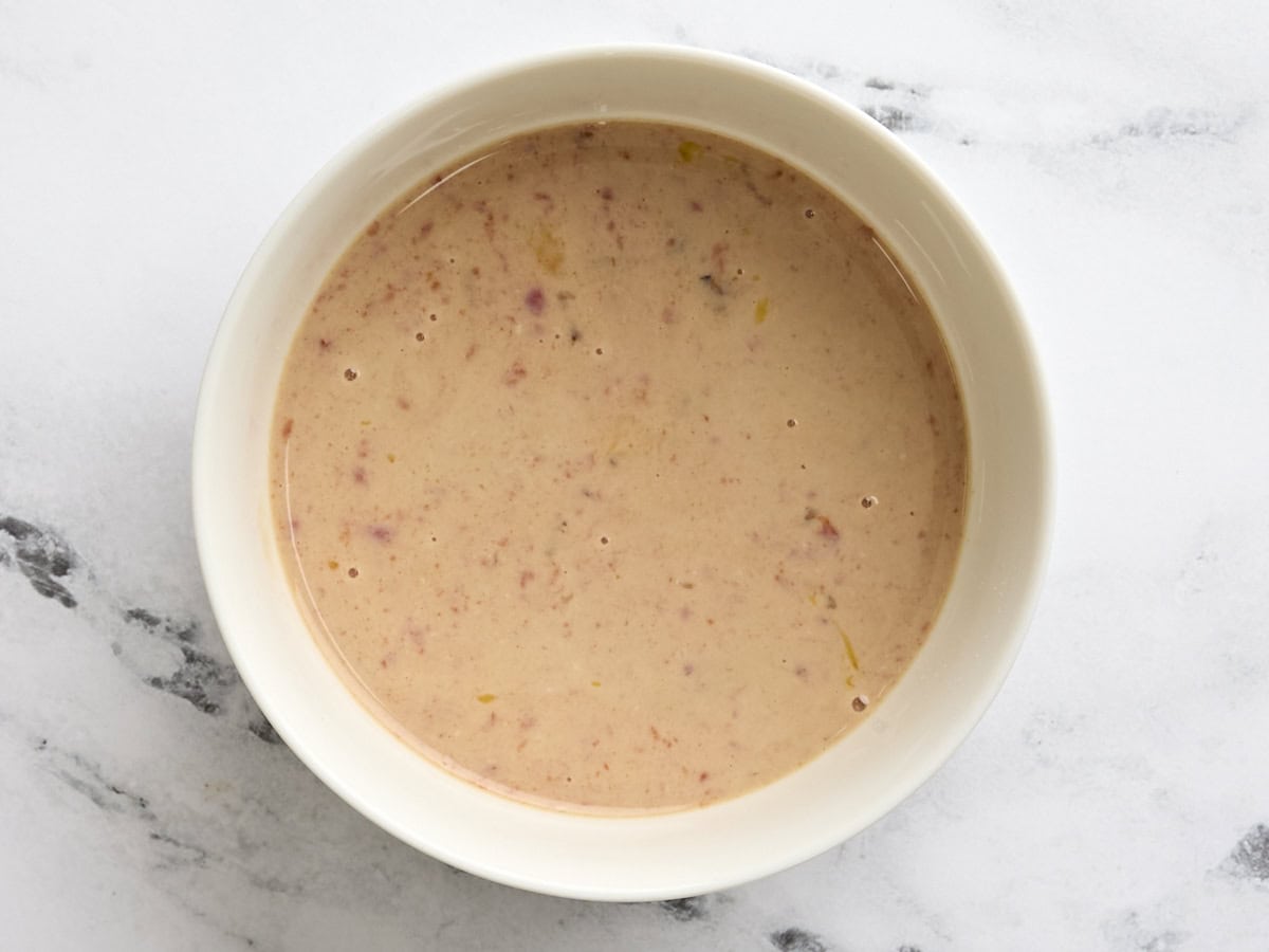 Milk, egg, and ketchup mixed together in a bowl.