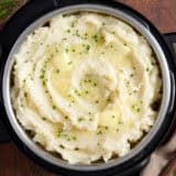 Overhead view of instant pot mashed potatoes topped with herbs.