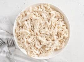 Overhead view of a bowl of pulled chicken.