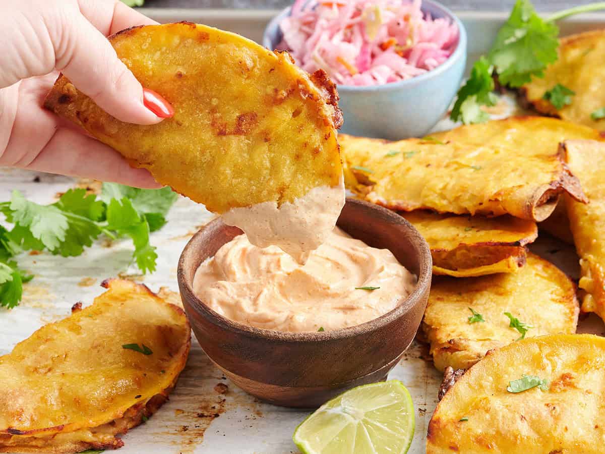 crispy baked taco dipped in sauce