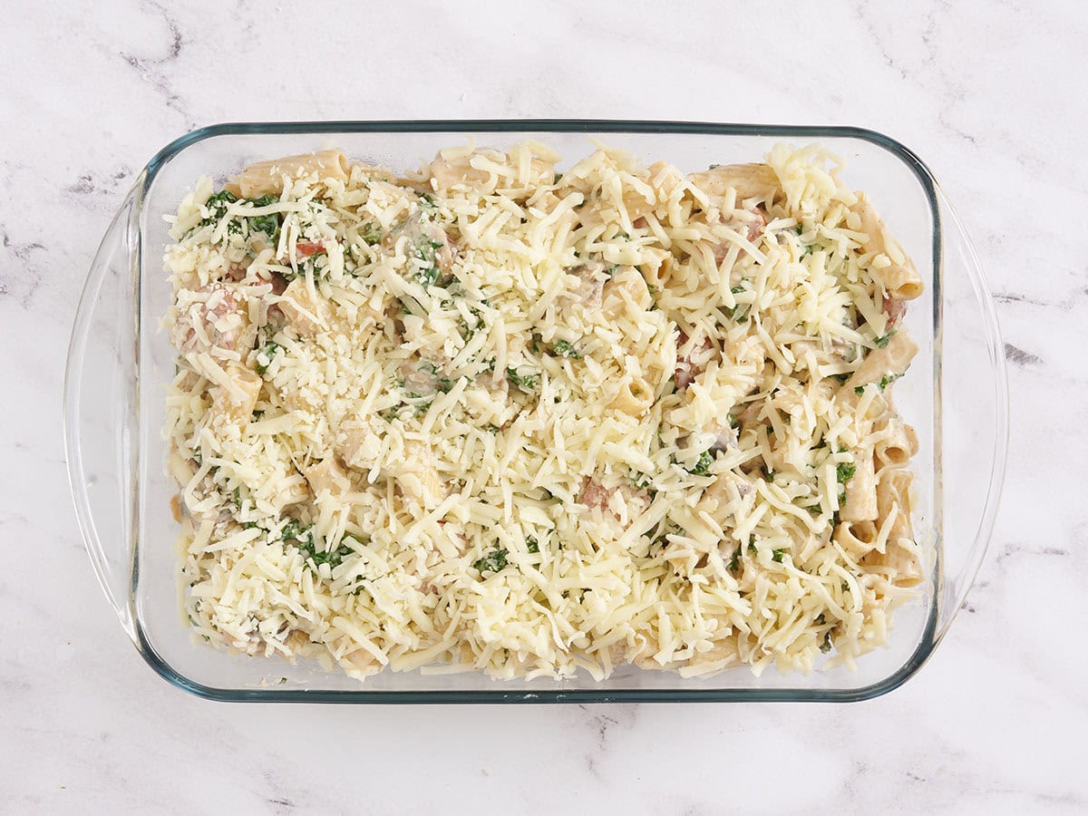 Turkey sausage and kale casserole in a baking dish topped with cheese.