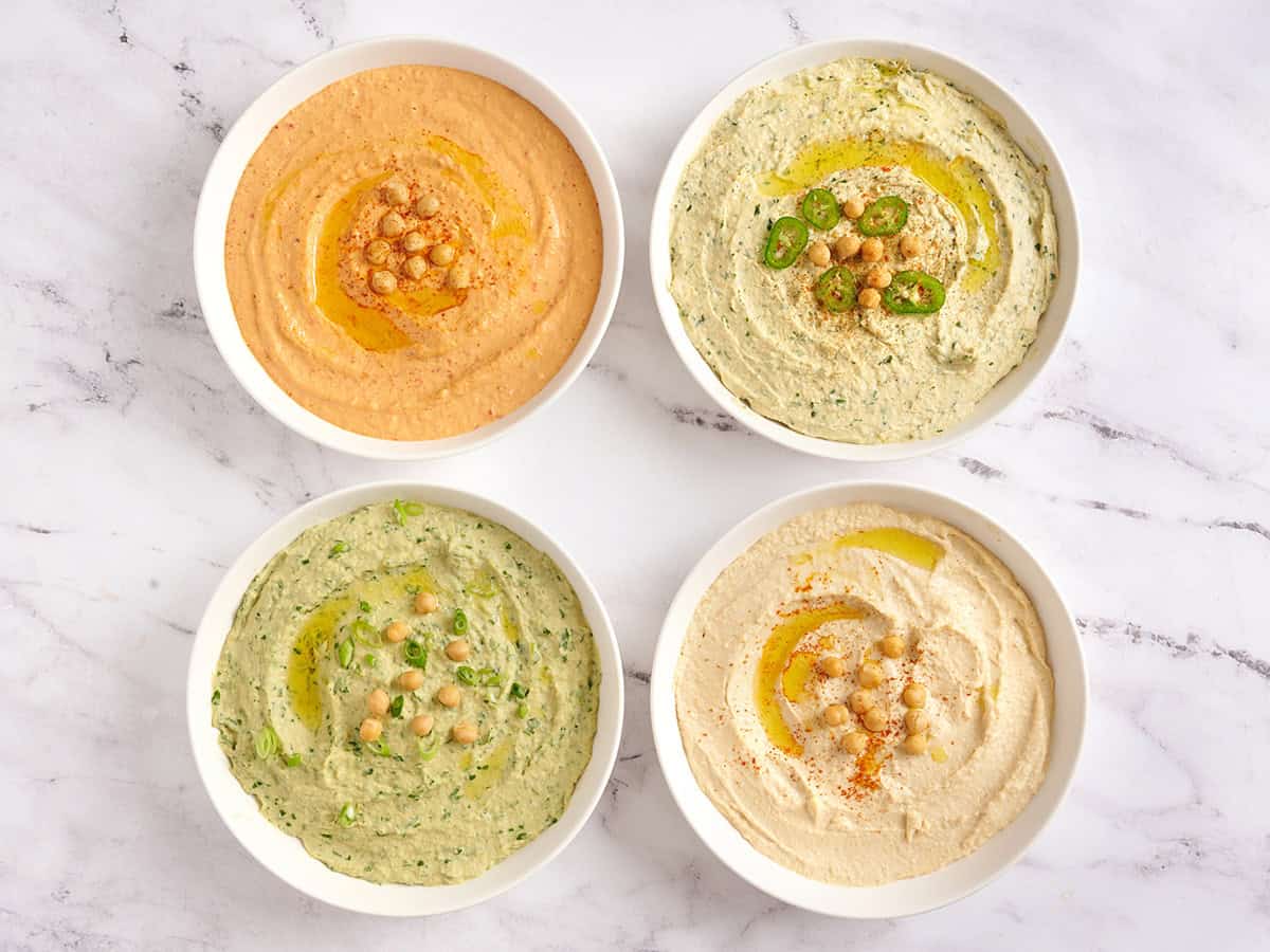 Overhead view of 4 types of homemade hummus.