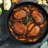 Overhead view of apple butter pork chops in a skillet.