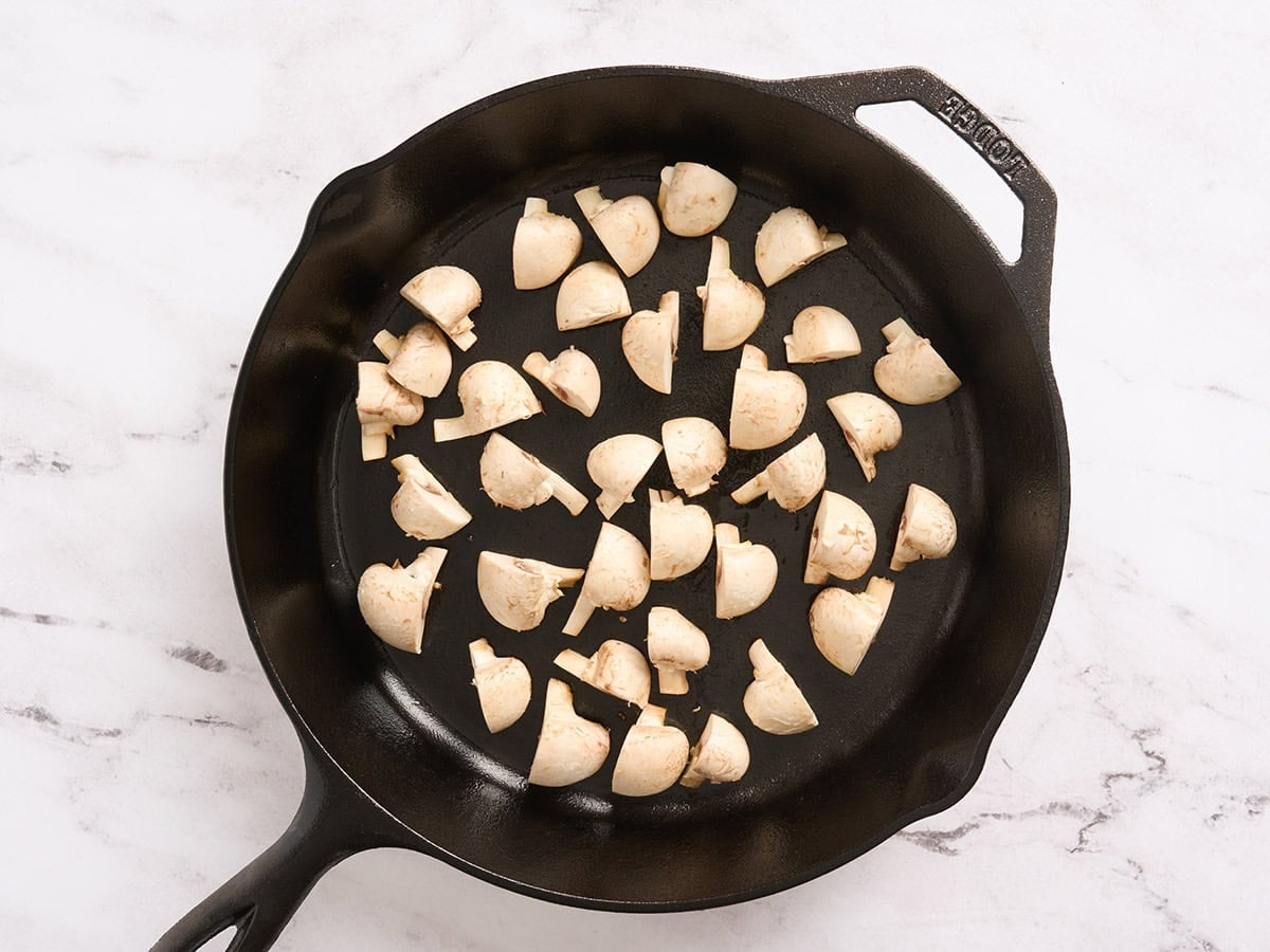 Chopped mushrooms in a cast iron skillet.