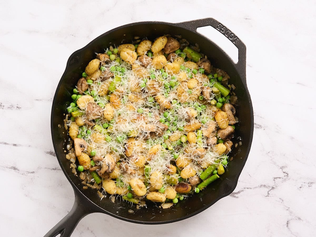 Finished vegetable gnocchi with parmesan cheese on top.