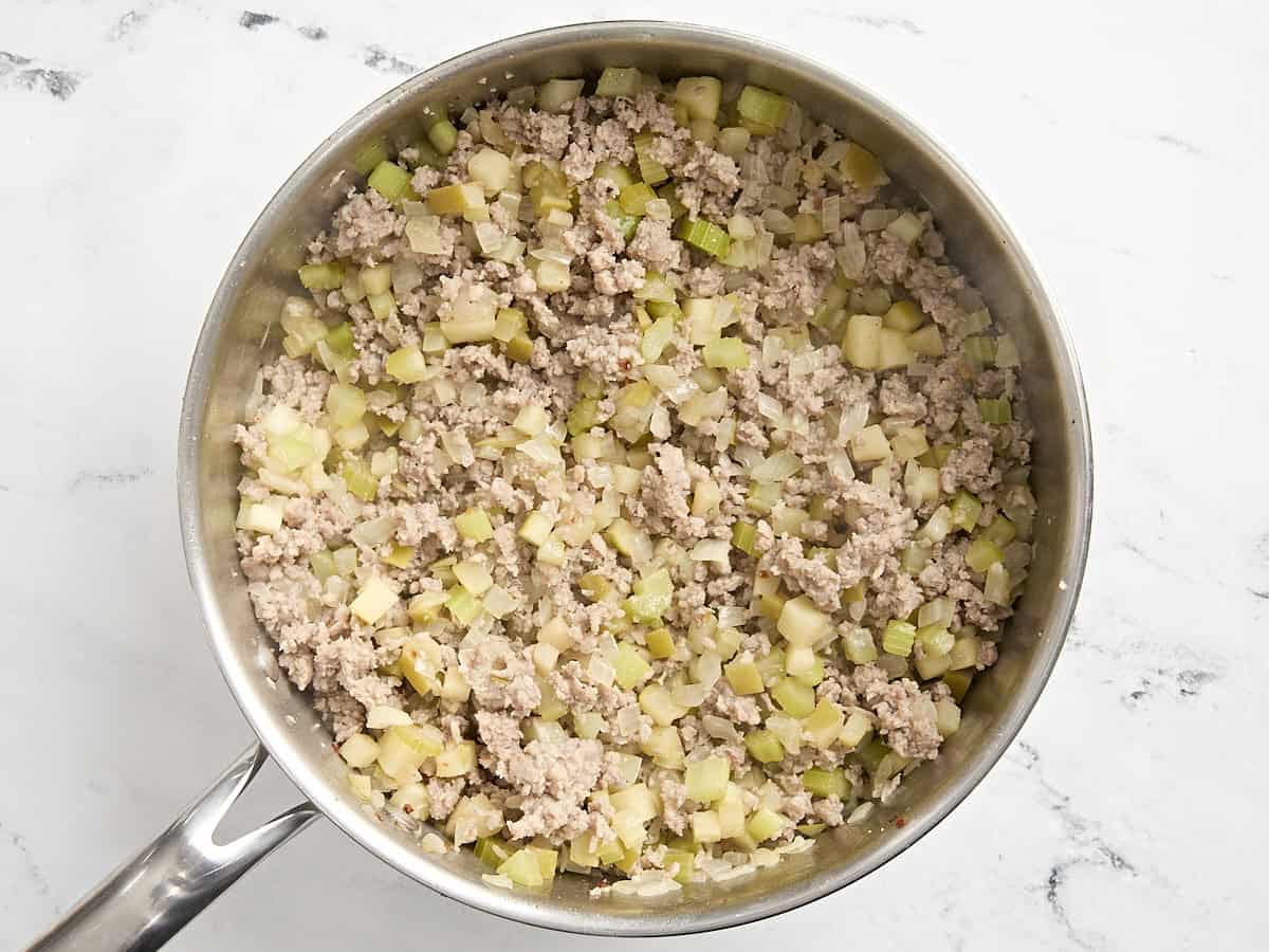 Browned ground sausage and vegetables in a pan.