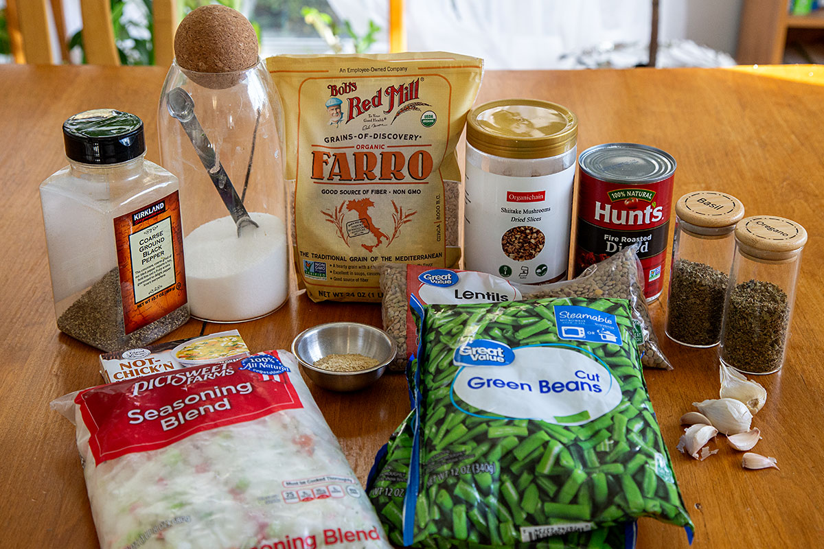 Ingredients for Soup: pepper, salt, farro, dried shiitake mushrooms, diced tomatoes, basil, oregano, bouillon, nutritional yeast, lentils, seasoning blend, green beans, garlic