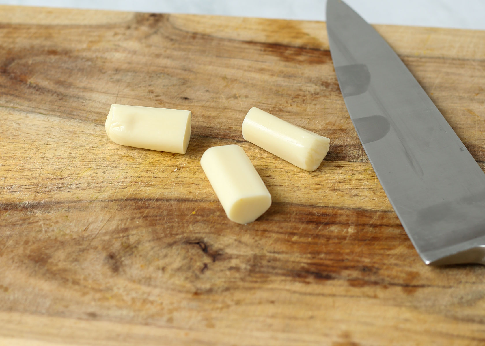 Cut the cheese into thirds for cheese and pretzel broomsticks.