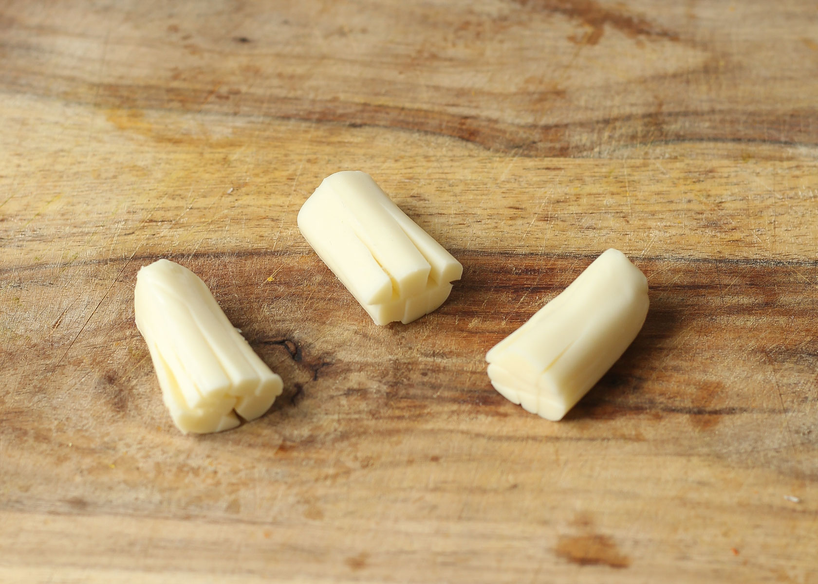 Cut the fringes into the cheese for cheese broomsticks.