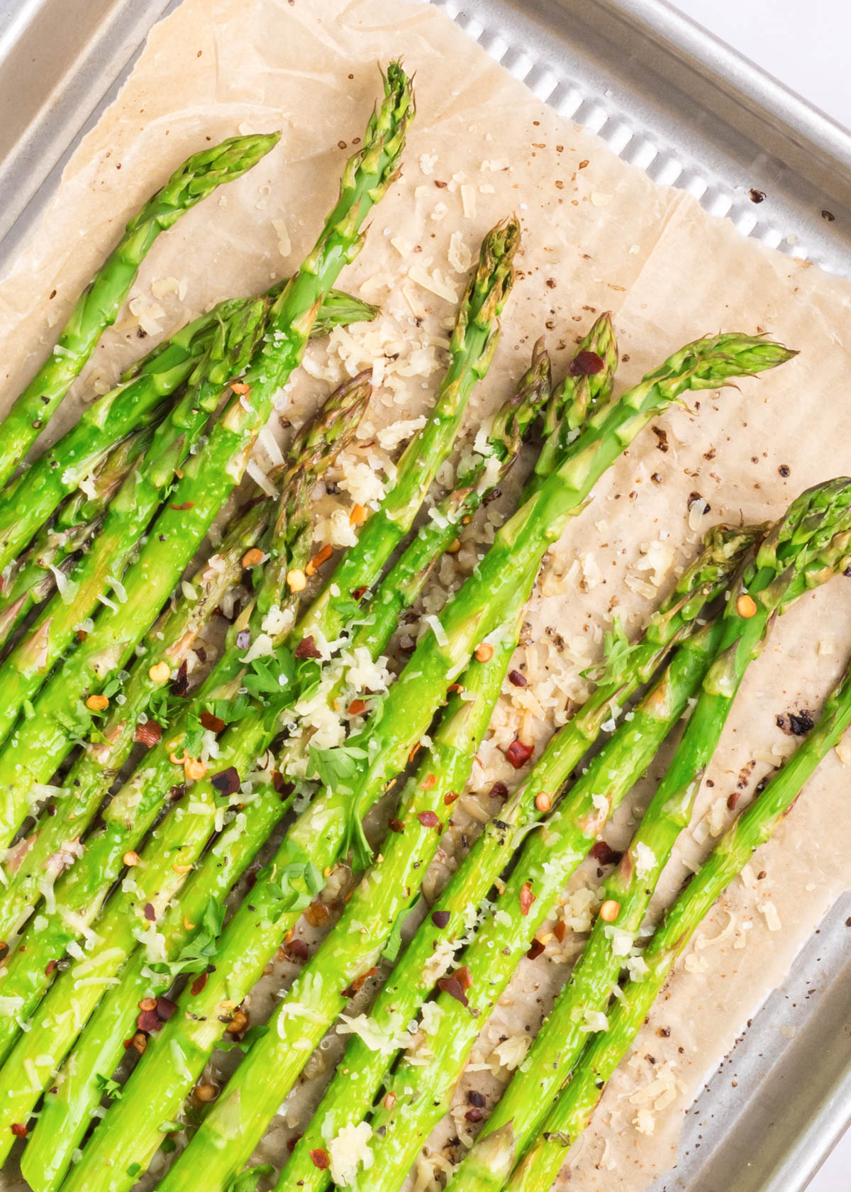 Parmesan roasted asparagus with crushed red pepper flakes, ready to serve.